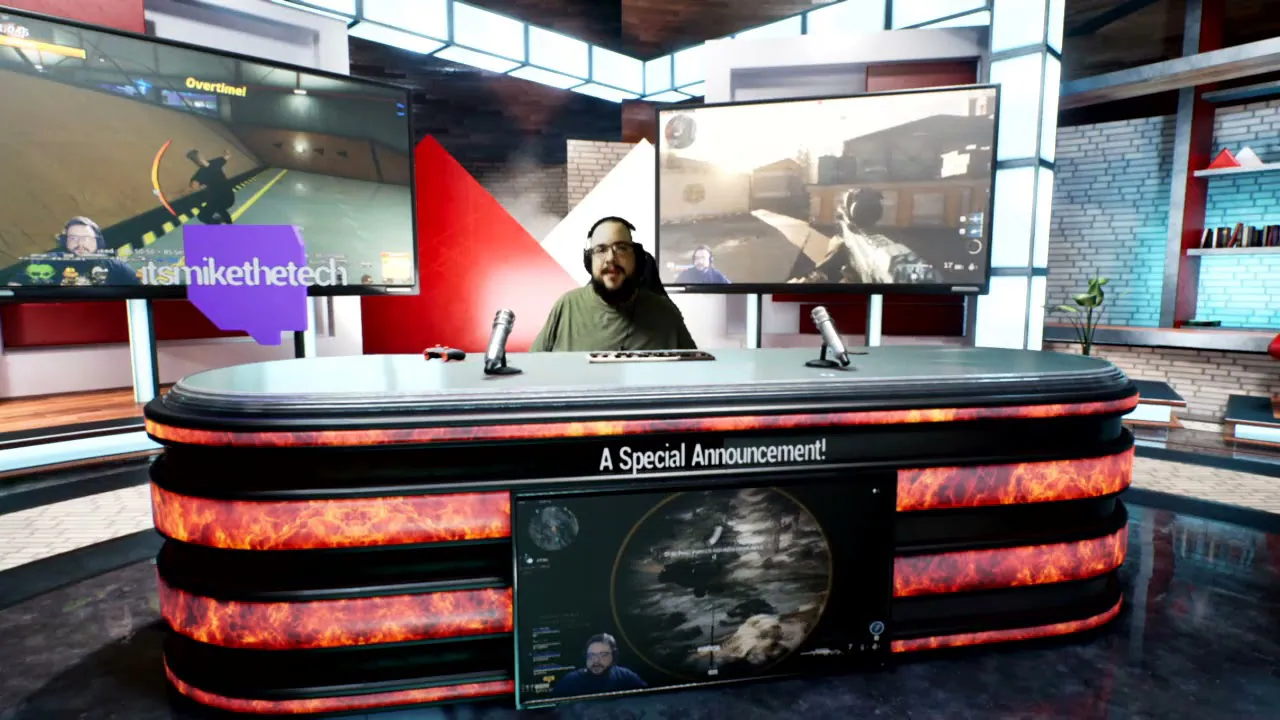 Mike at a flame-panel desk in the March 2021 virtual studio set